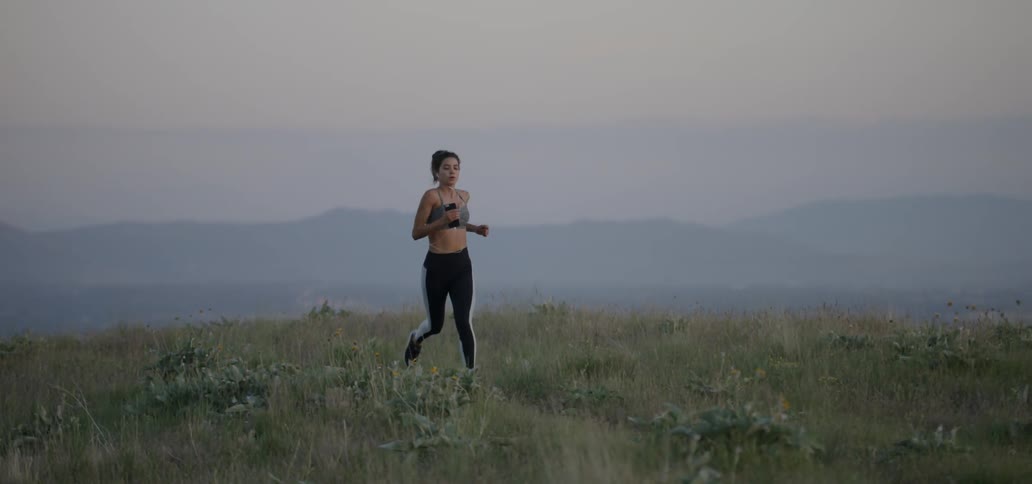 A woman jogs in a field