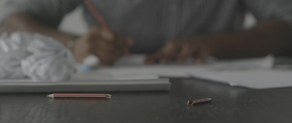 A man draws and erases on paper