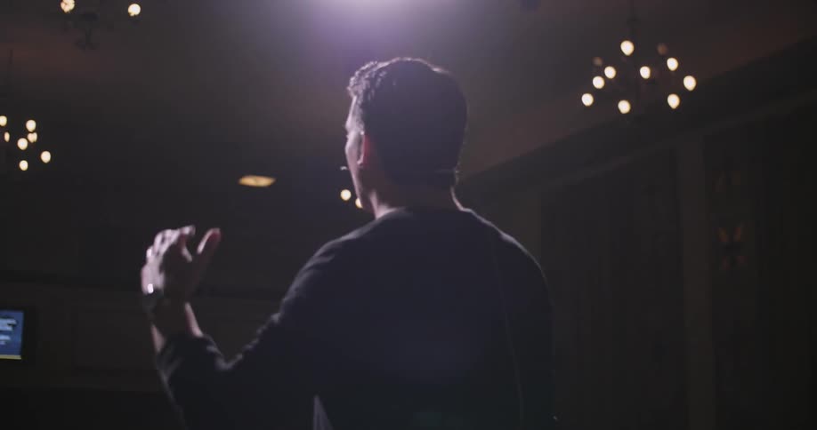 A man wearing black is giving a speech