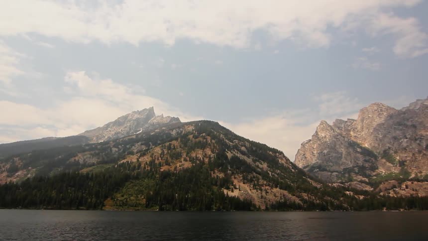 Mountains and pine trees surround a lake