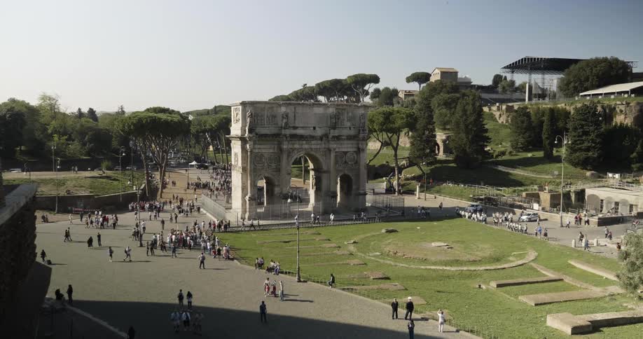 People walk near stone ruins
