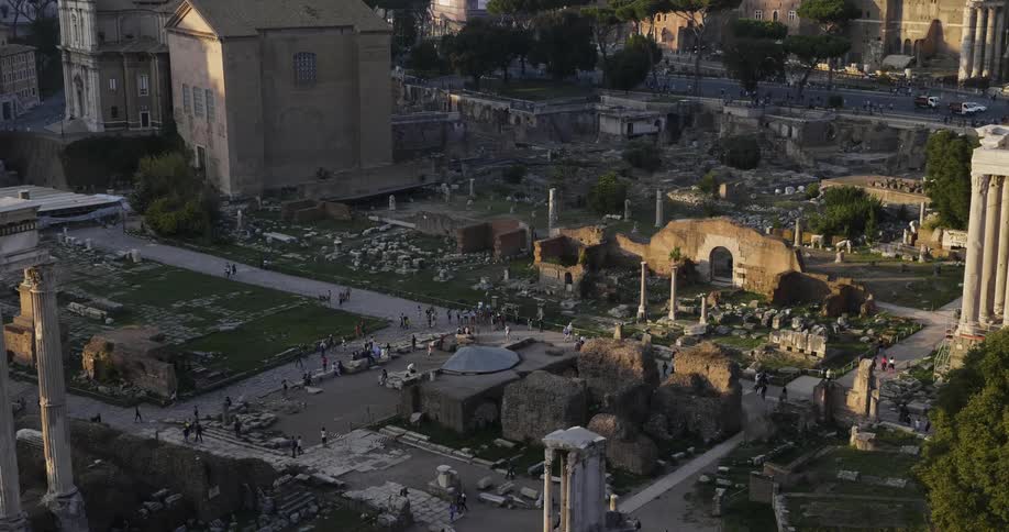 People tour stone ruins in a city