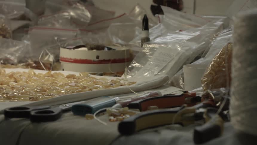 Stones, tools, and baggies sit on a table in a workshop