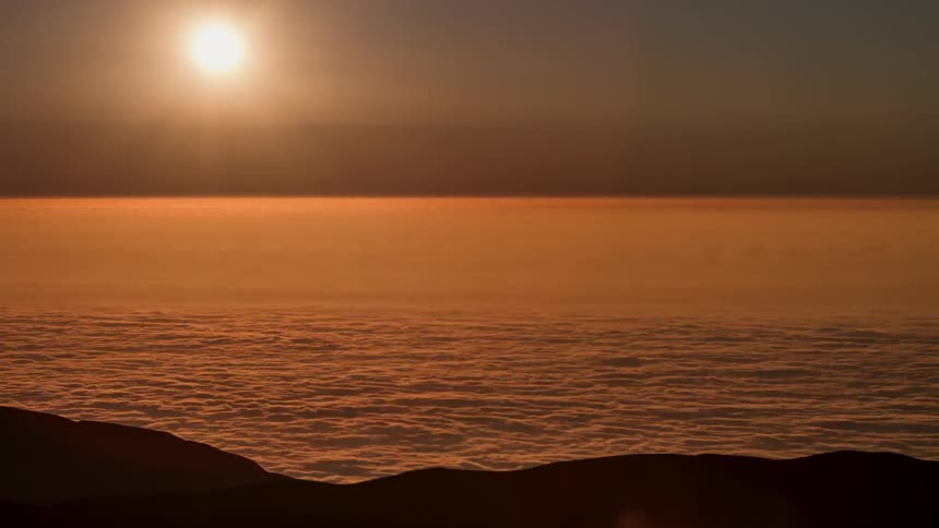 The sun sets over an ocean