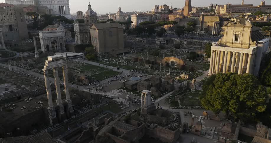 People walk on paths around ancient ruins
