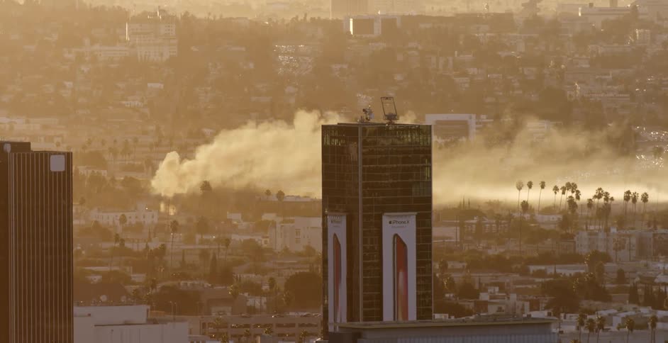 Smoke plumes off the street below