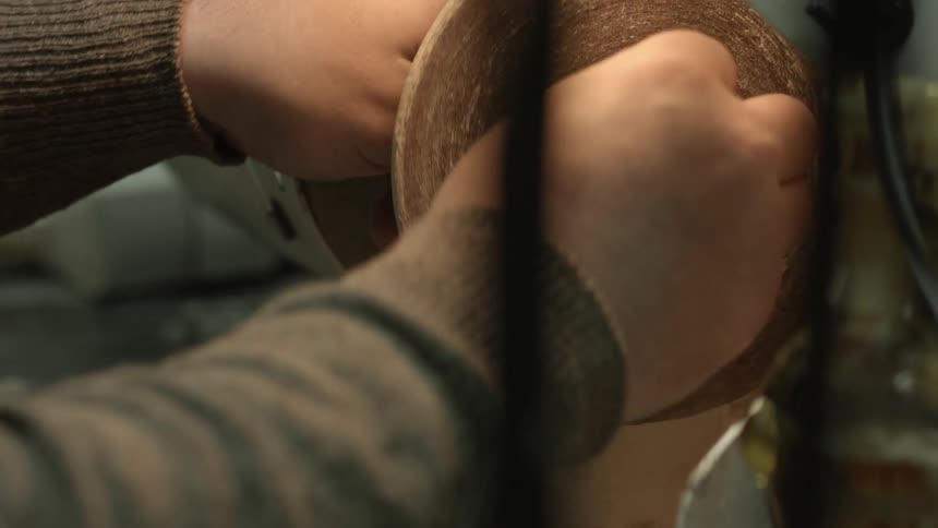 A person attaches pieces to a power tool