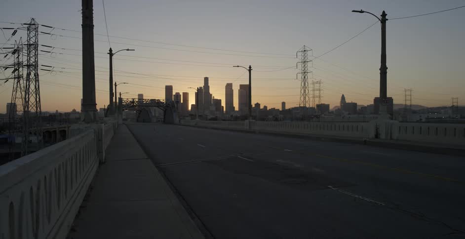 View of a highway leading into a city with tall skyscrapers