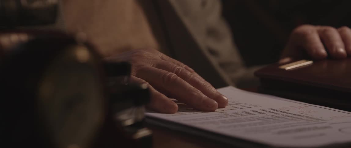 A man reads a paper contract