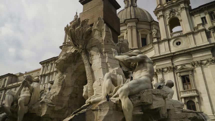 Statue of naked people in front of a government building