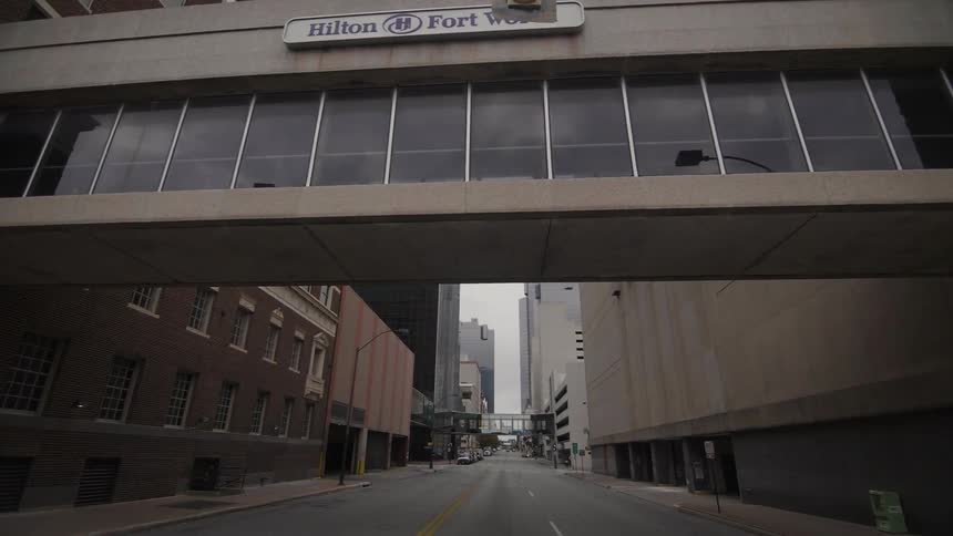 View of a walkway in between two buildings over a city street