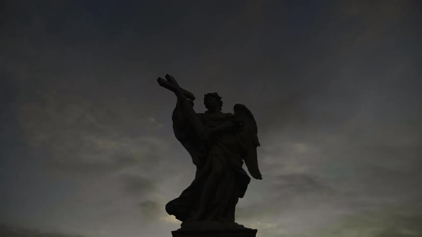 Silhouette of a statue holding a cross