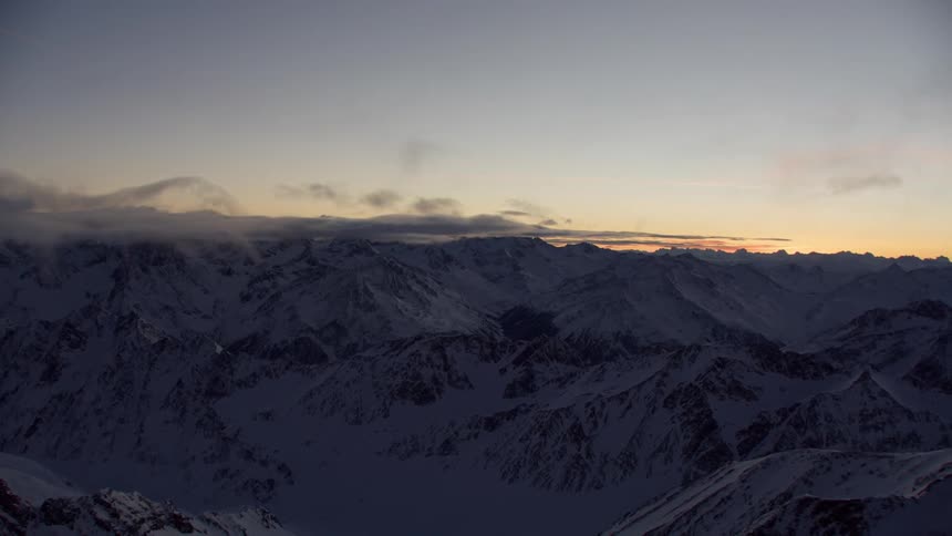 The mountains are covered with clouds and snow