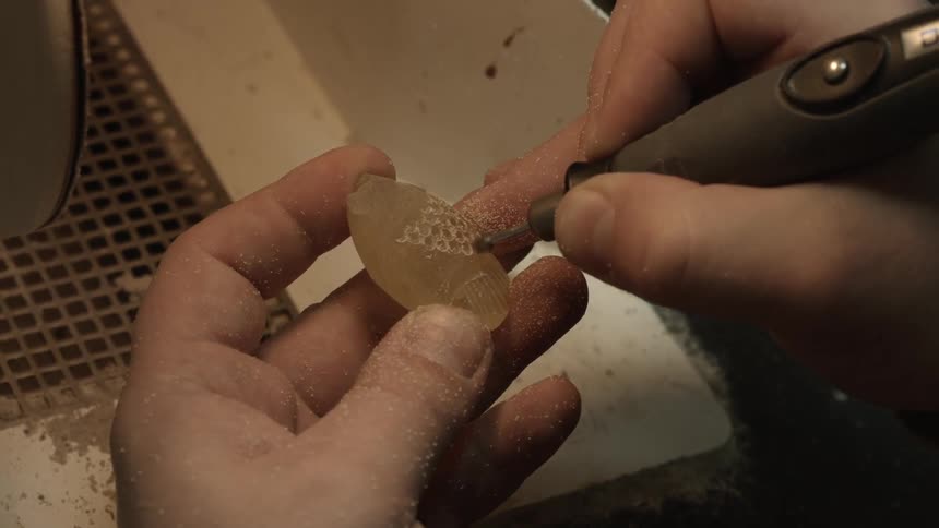 Person carving a piece of stone