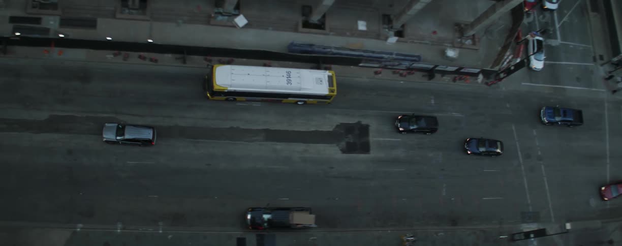 Cars drive on a city street