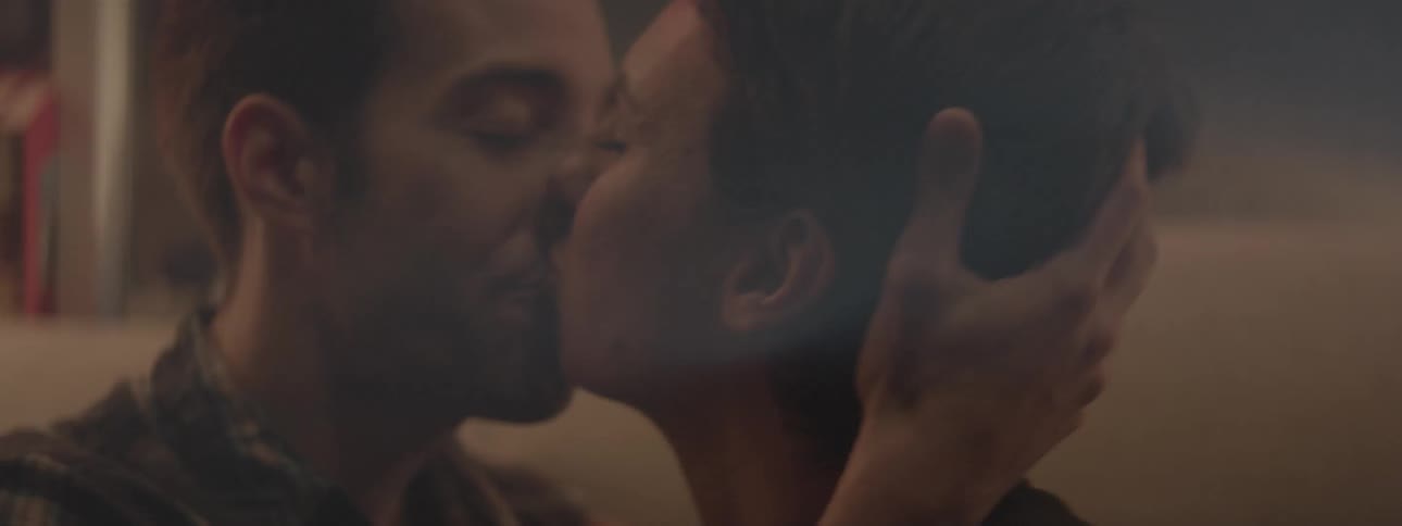 A man and women kiss deeply