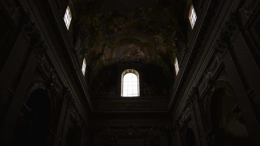 Sunlight coming through windows illuminates the interior of an ornately decorated church