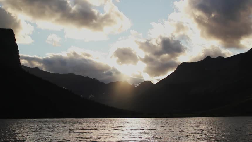 Sun shafts on a mountainside lake