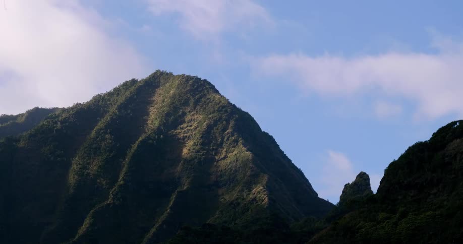 Clouds float over a mountain ridge