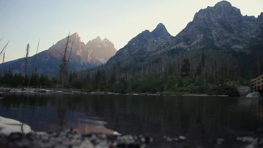 Water flowing in front of tall mountains