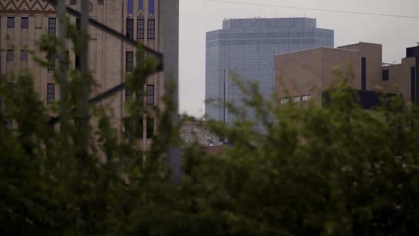 City buildings are shown on a sunny day