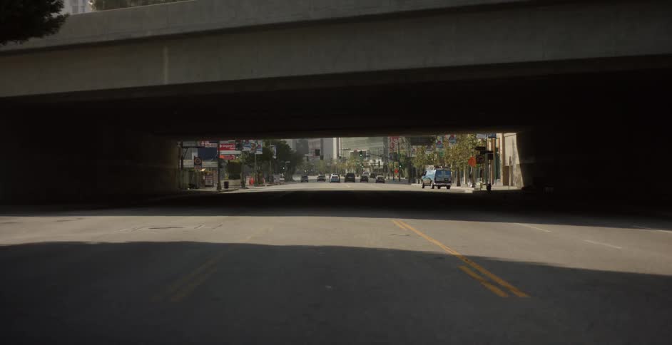 View looking through a tunnel at the city