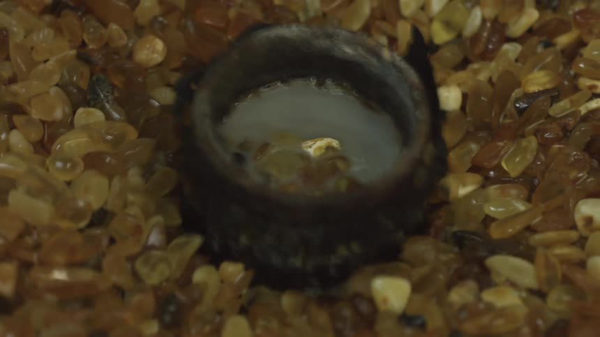 Yellow pebbles in a grinder