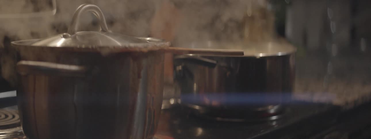 The pots on the stove are over boiling