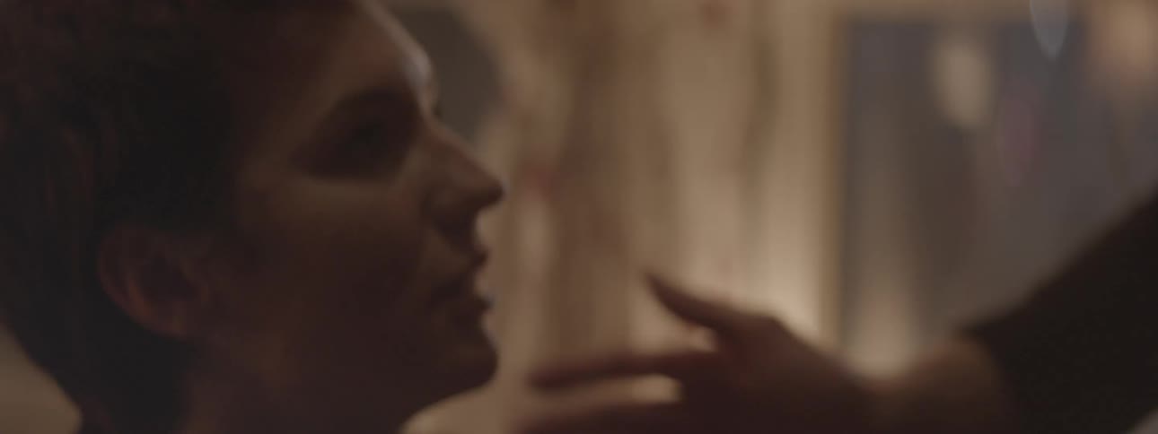 A man leans in to kiss a woman