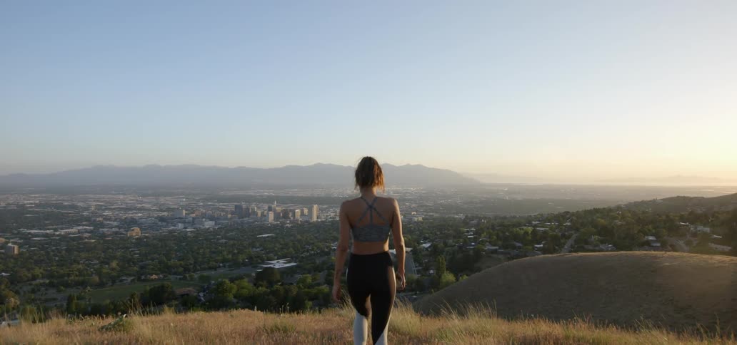 A woman walks down a hill