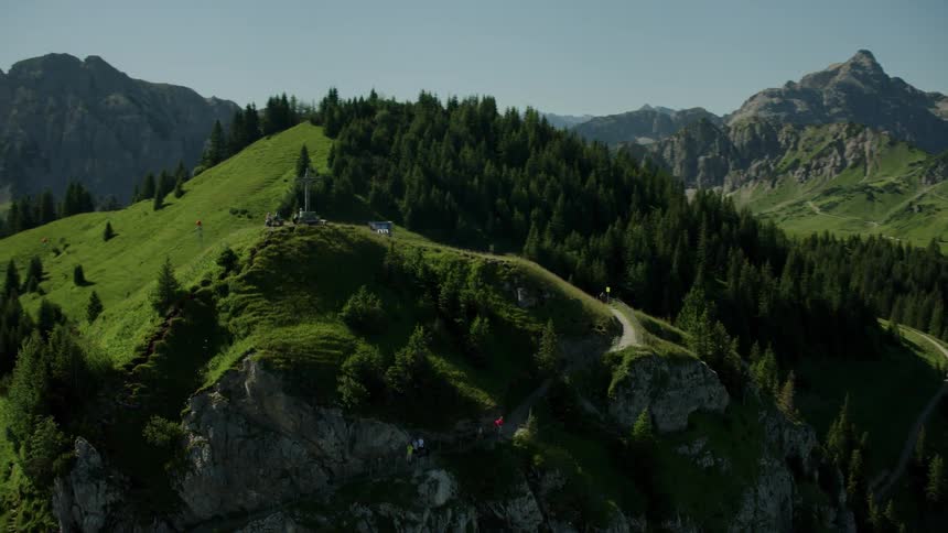 People are hiking on the mountain top on a sunny day
