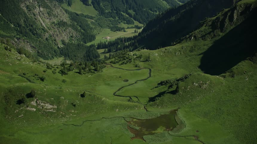 Aerial view of a river flowing in a green valley
