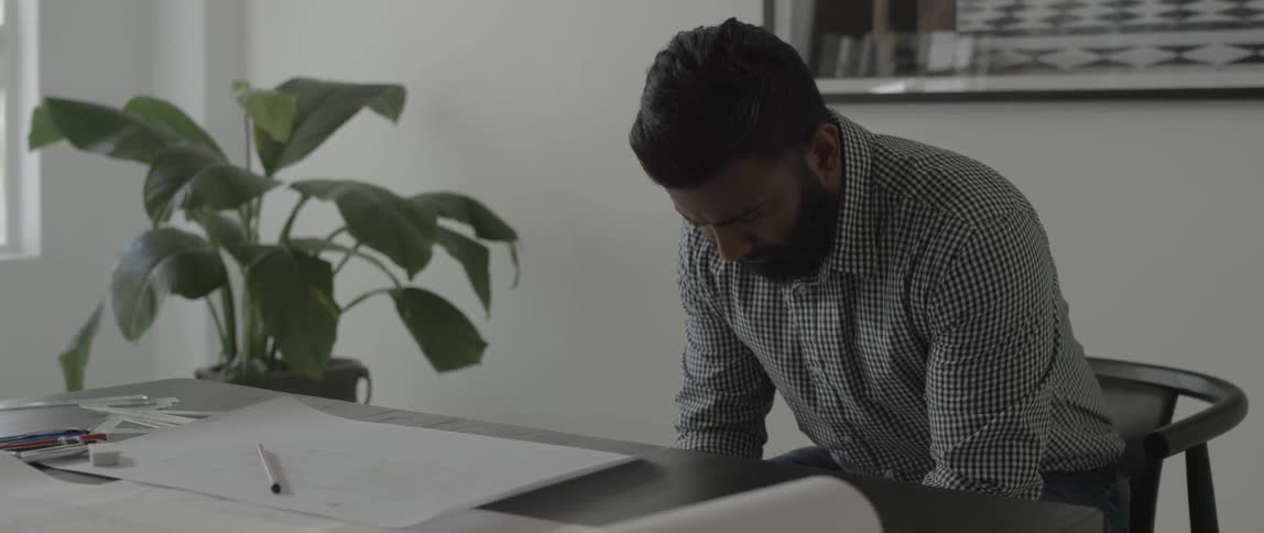 Man sitting at a desk looking down