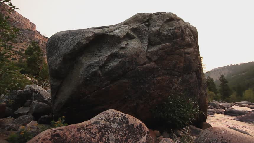 View of a large boulder and a stream flowing near it