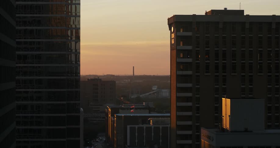 View of apartment buildings in a city at sunset