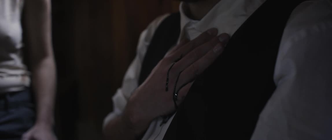 Man holding his chest while blood drips down his hand