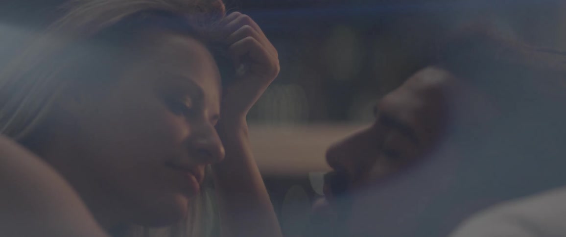 Man and woman laying in bed and talking