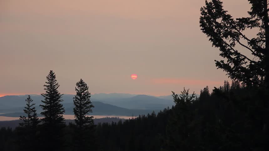 The sun sets over mountains