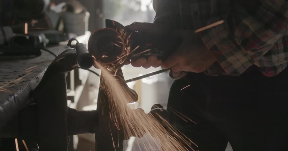 A man saws a metal pipe