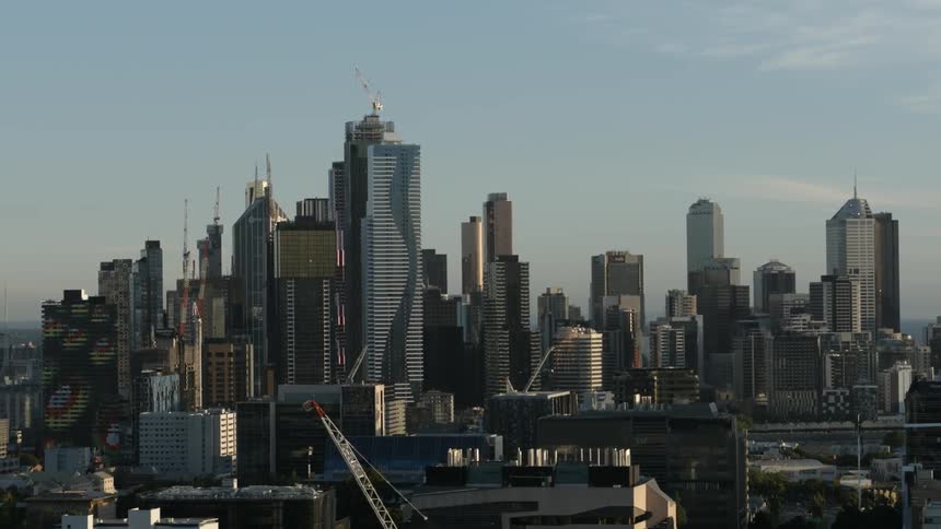 A cityscape is shown on a sunny day