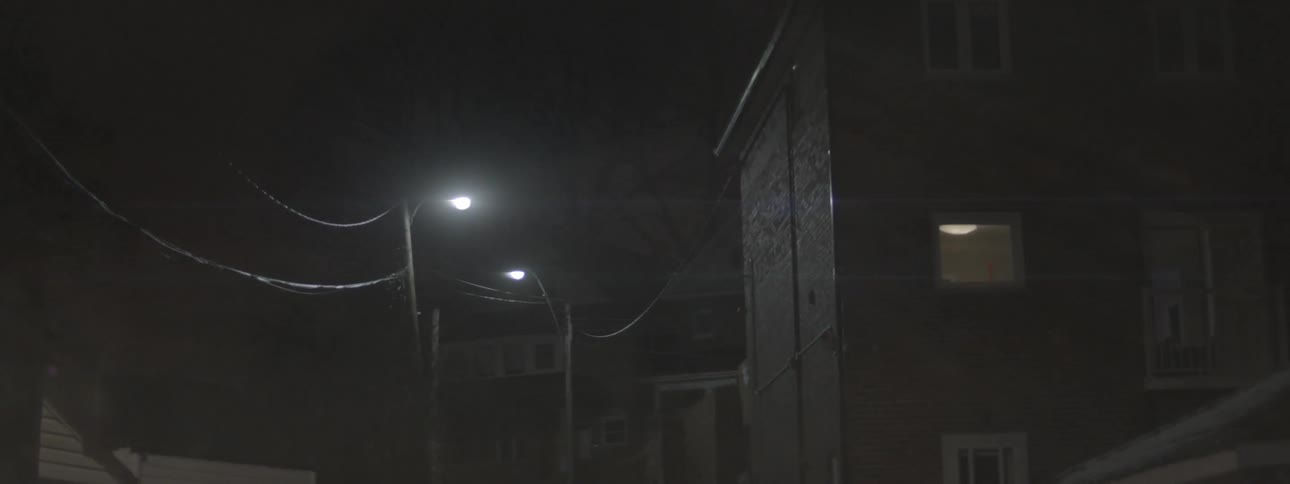 The street lights line the road at night