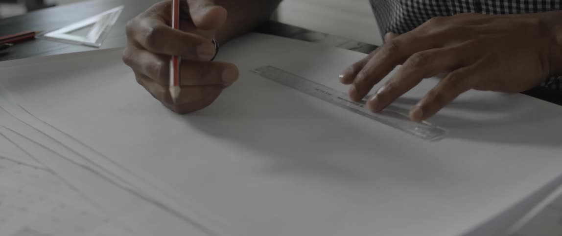 Person putting a ruler on a piece of paper