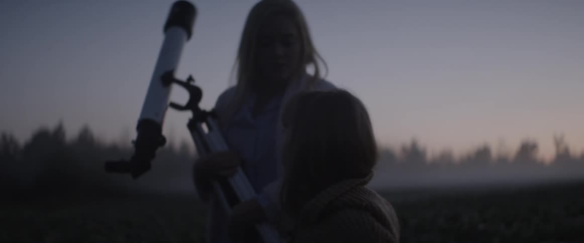Woman and daughter outdoors walking with a telescope