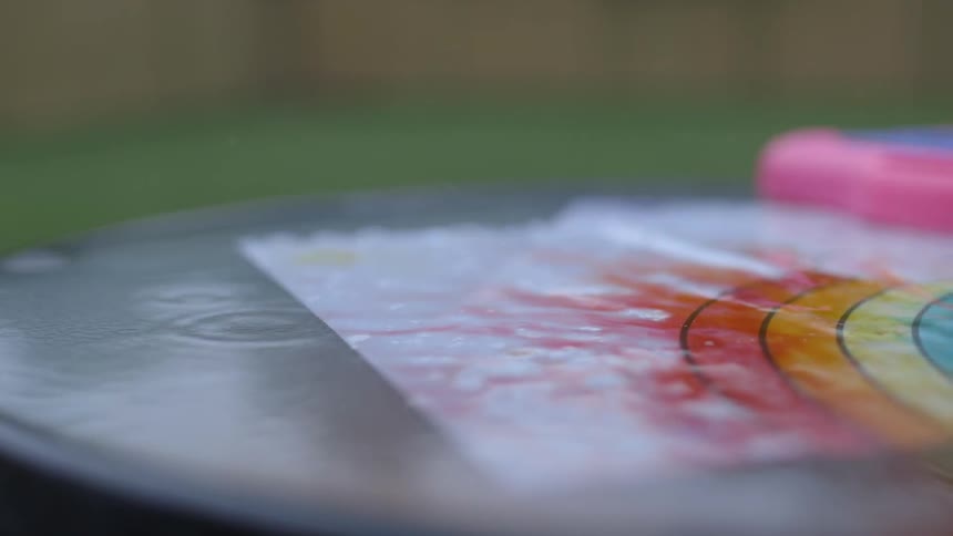 Rain falls on a coloring and makes the colors bleed