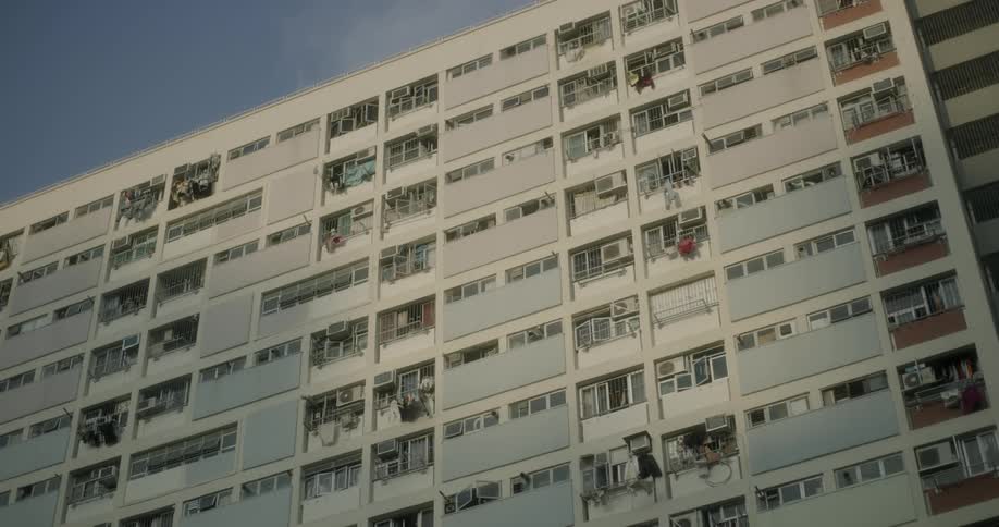 An apartment building stands overhead