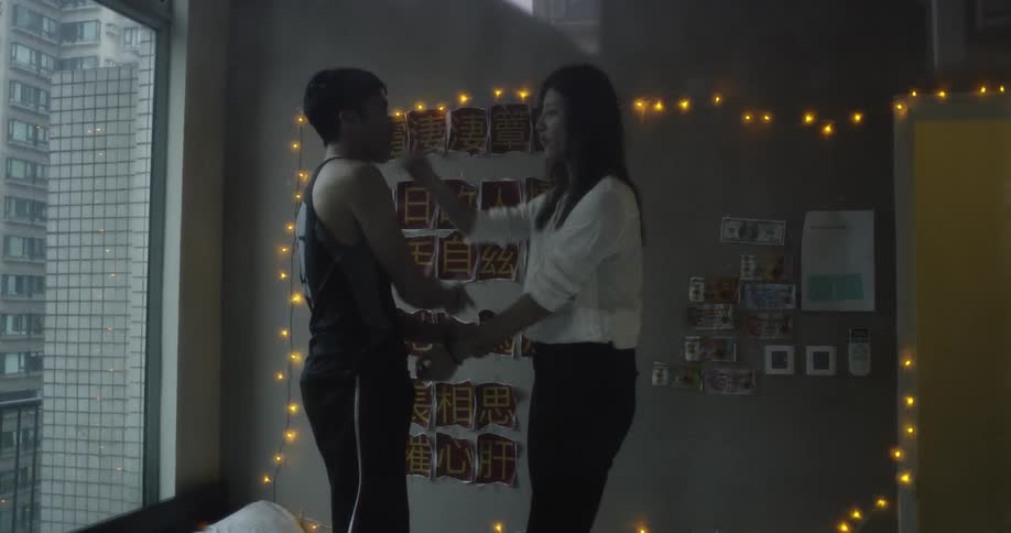 A couple play fight in their room