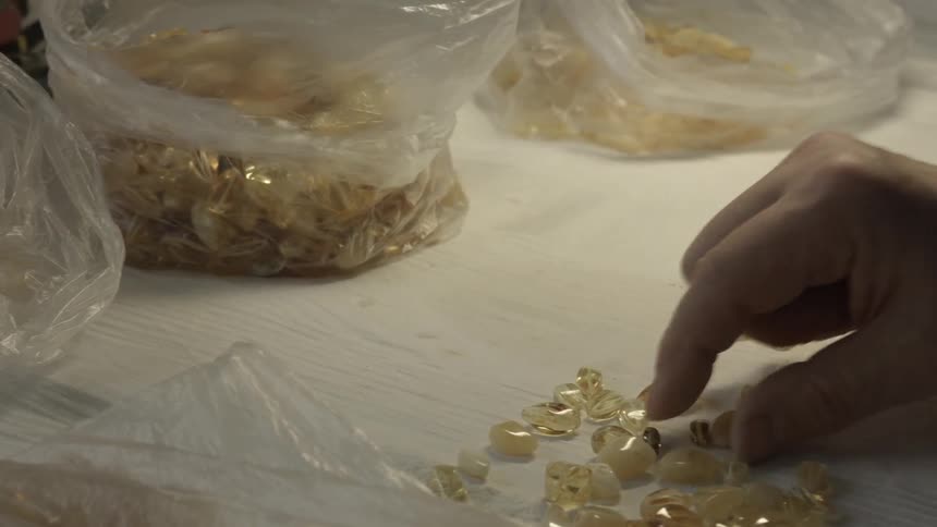 Person sorting gems into bags