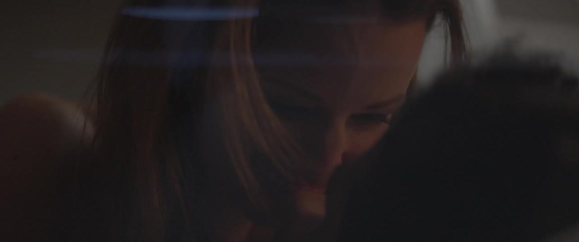 A woman smiles and touches someone