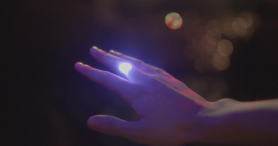 Light shines on a person's hand
