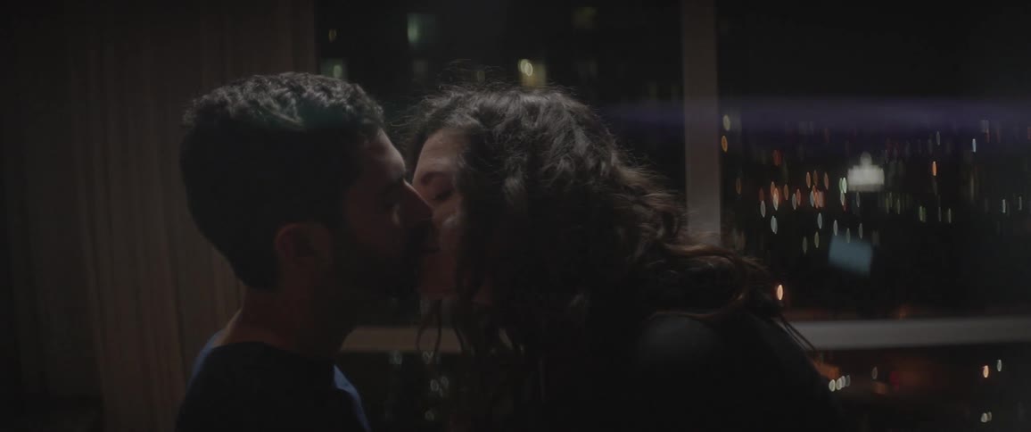 A man and woman kiss each other